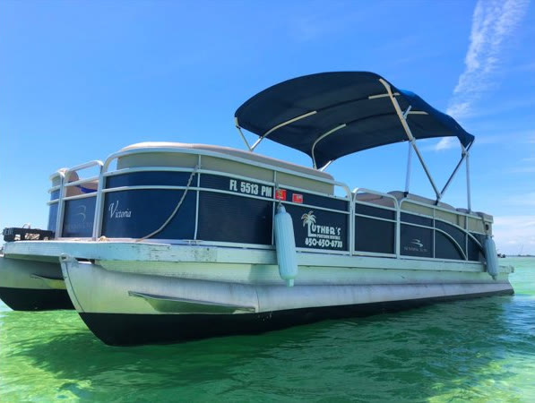 A Luther's 28 foot pontoon with a navy bimini top